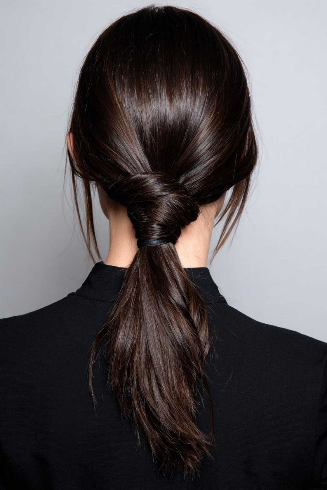 19+ Cute Ways to Wear Your Hair Up (Top Knots & Face-Framing Looks!) - 8. Knotted Low Ponytail